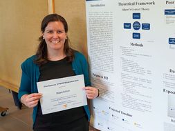 Maggie Roberts posing with her award from student research day.
