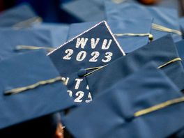 A lone graduation caps in a sea of others highlights 2023 