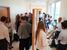 A crowded hallway of students presenting their posters