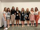 Eight high school students stand together; all have received the teaching scholarship.