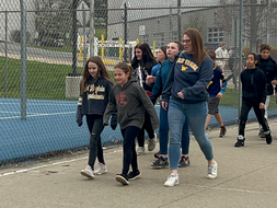Students from Crellin elementary walk outside on a tour with WVU students and faculty.