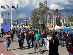 A photo of tourists outside of an athletics venue at the 2023 Pan American Games.
