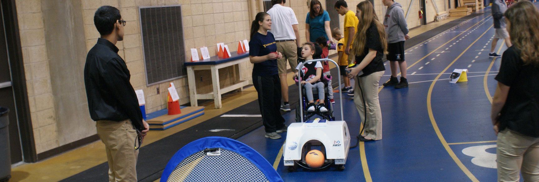 Students using a ball kicking robot